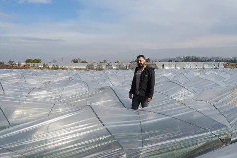 Image of a farmer standing in the field of his farmer