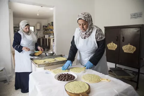 Image of two ladies making bread in a bakery